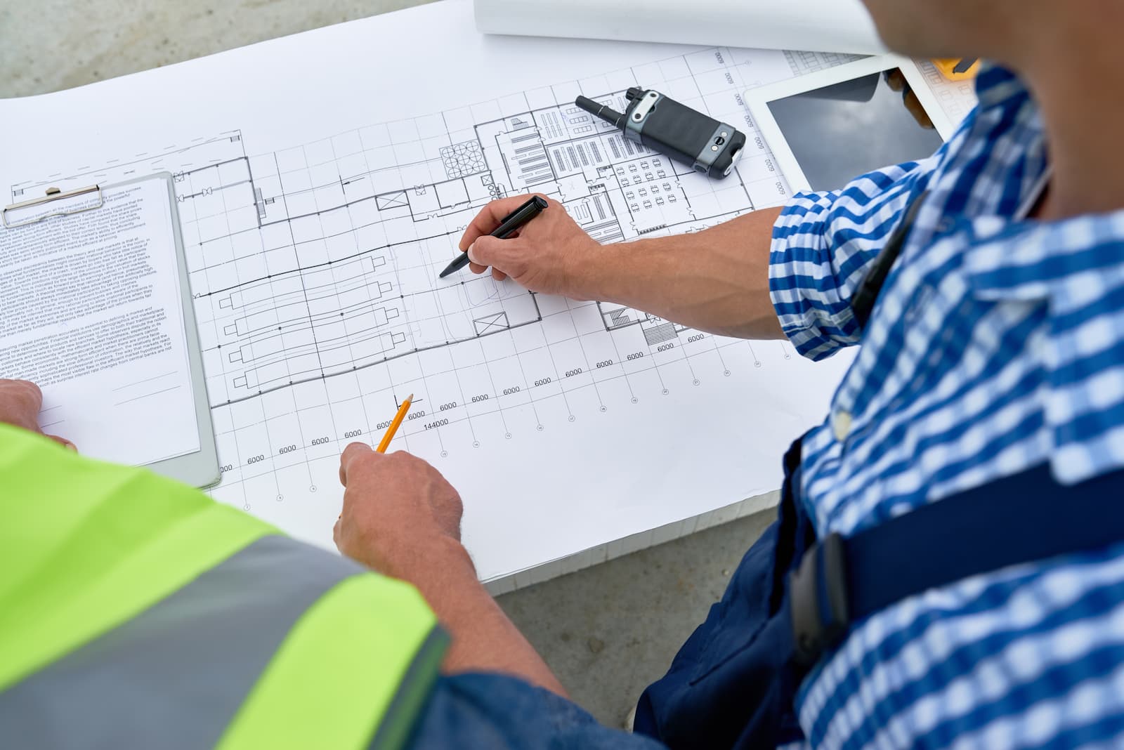 PNW Construction and Energy Services experts looking at floor plans