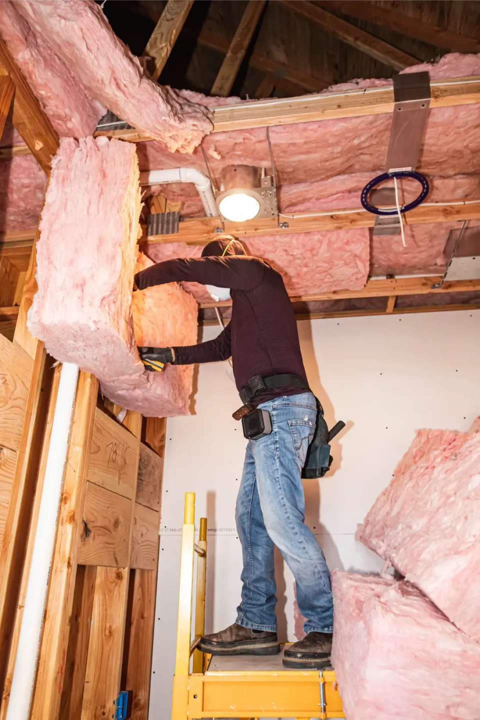 Washington Insulation installing insulation in the ceiling.