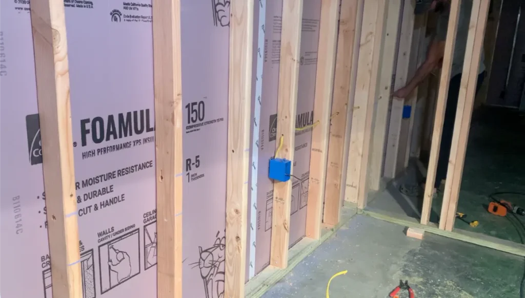 Rigid foam board insulation installed between wall studs.