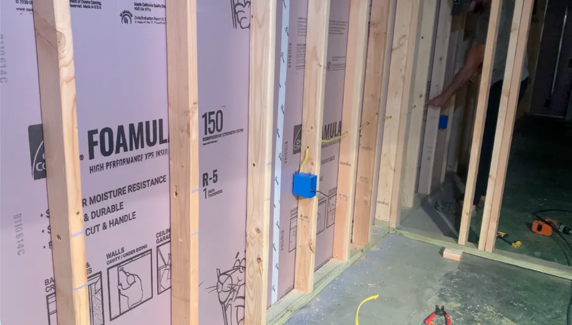 Rigid foam board insulation installed between wall studs.